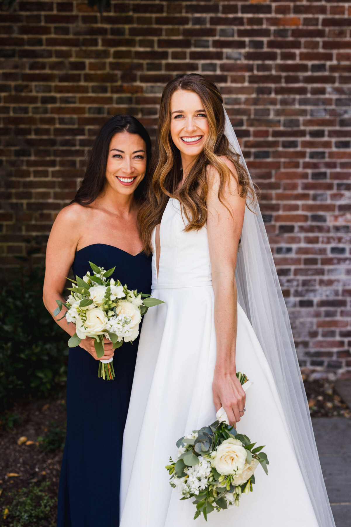 portraits of a bride and bridesmaid outside pelham house