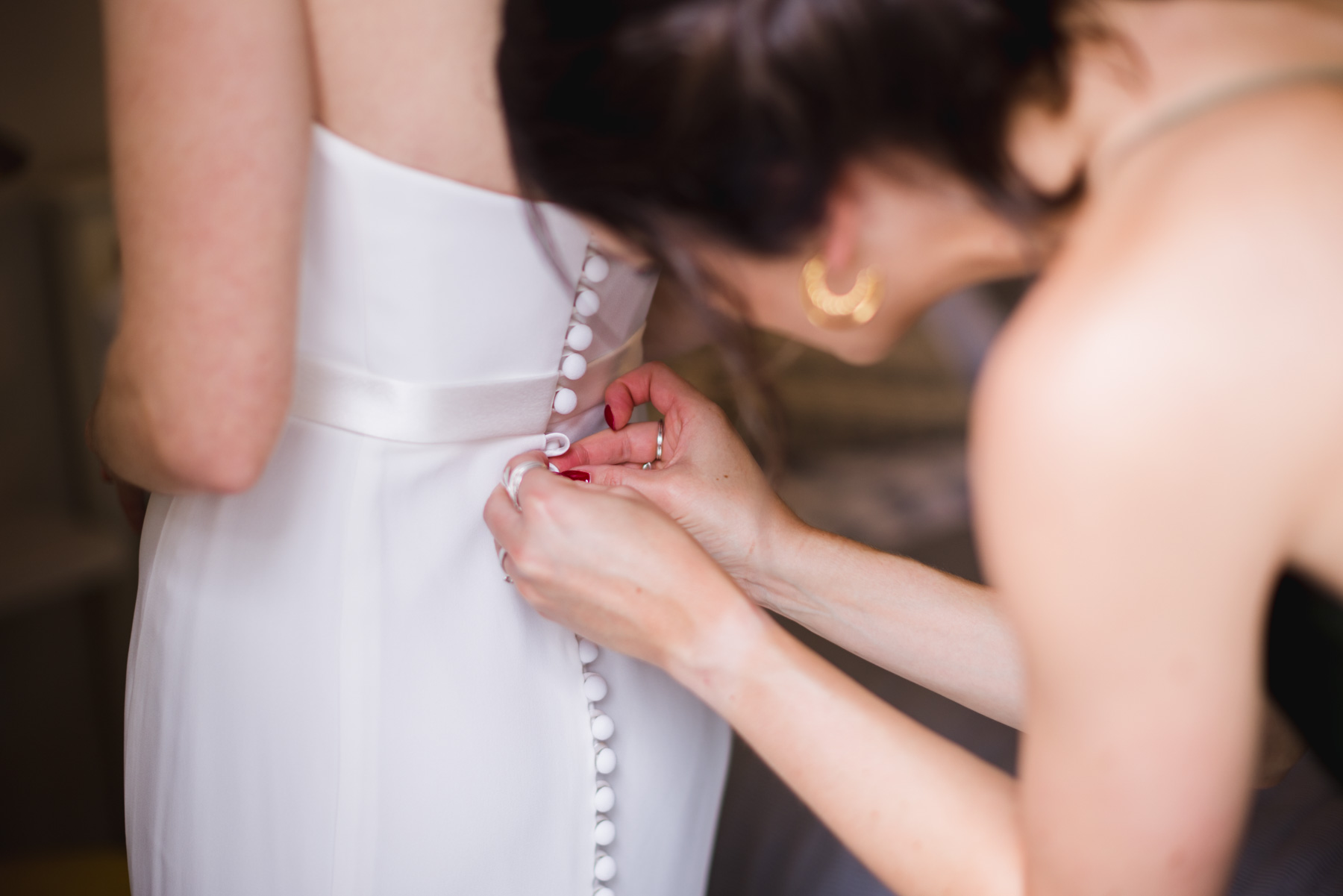 Doing up the wedding dress ahead of a Firle Wedding