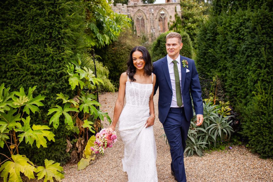 Wedding couple walking through Nymans Gardens National Trust