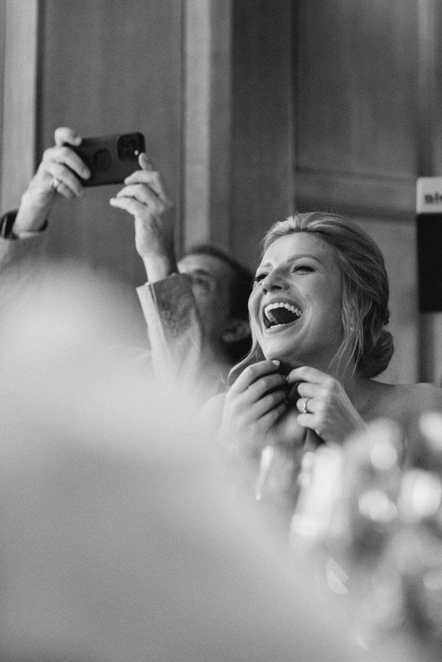Bride laughing during speeches at Balcombe Place